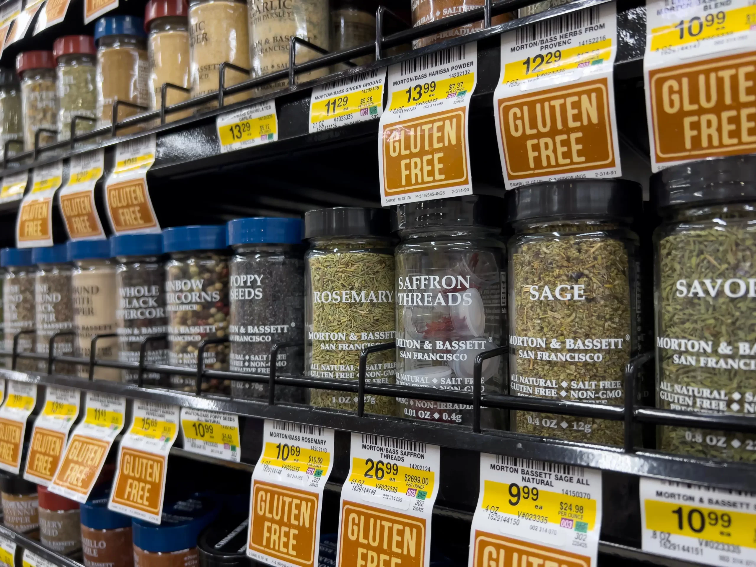 Wide view of Morton and Bassett seasonings for sale inside a grocery store.